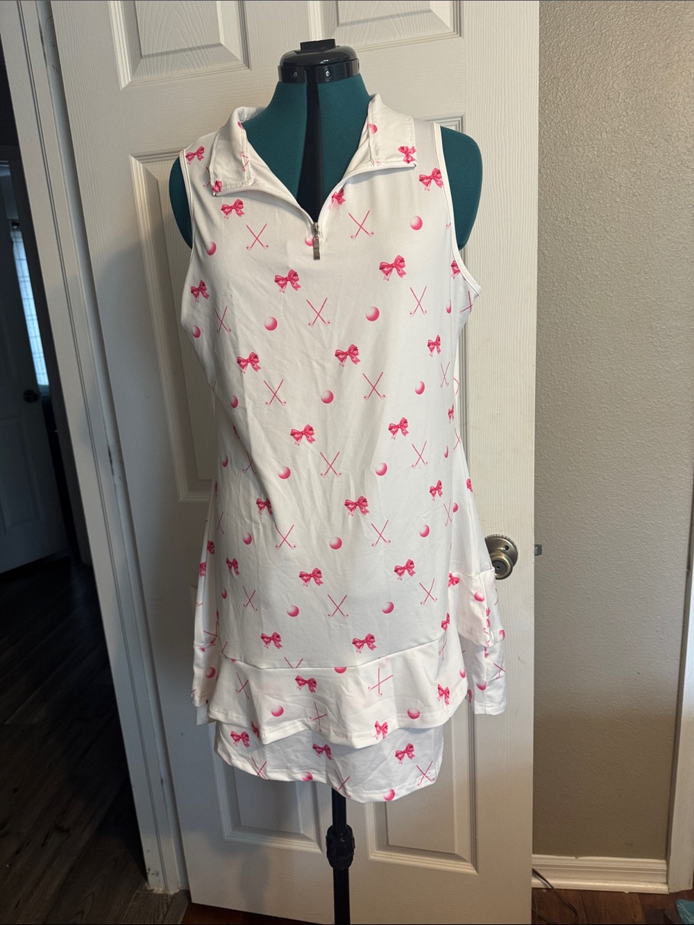 Amazon White Sleeveless Golf Skort Dress with Pink Bow Print.